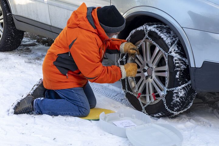 Snow chains being installed outside